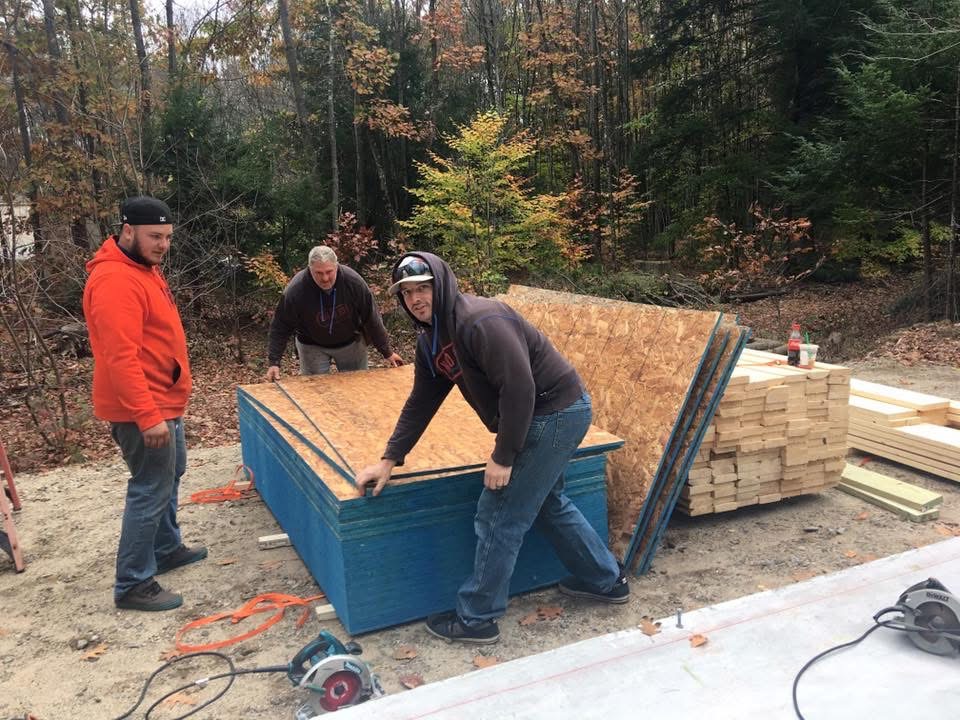 JT Construction crew moving structural panels on a jobsite