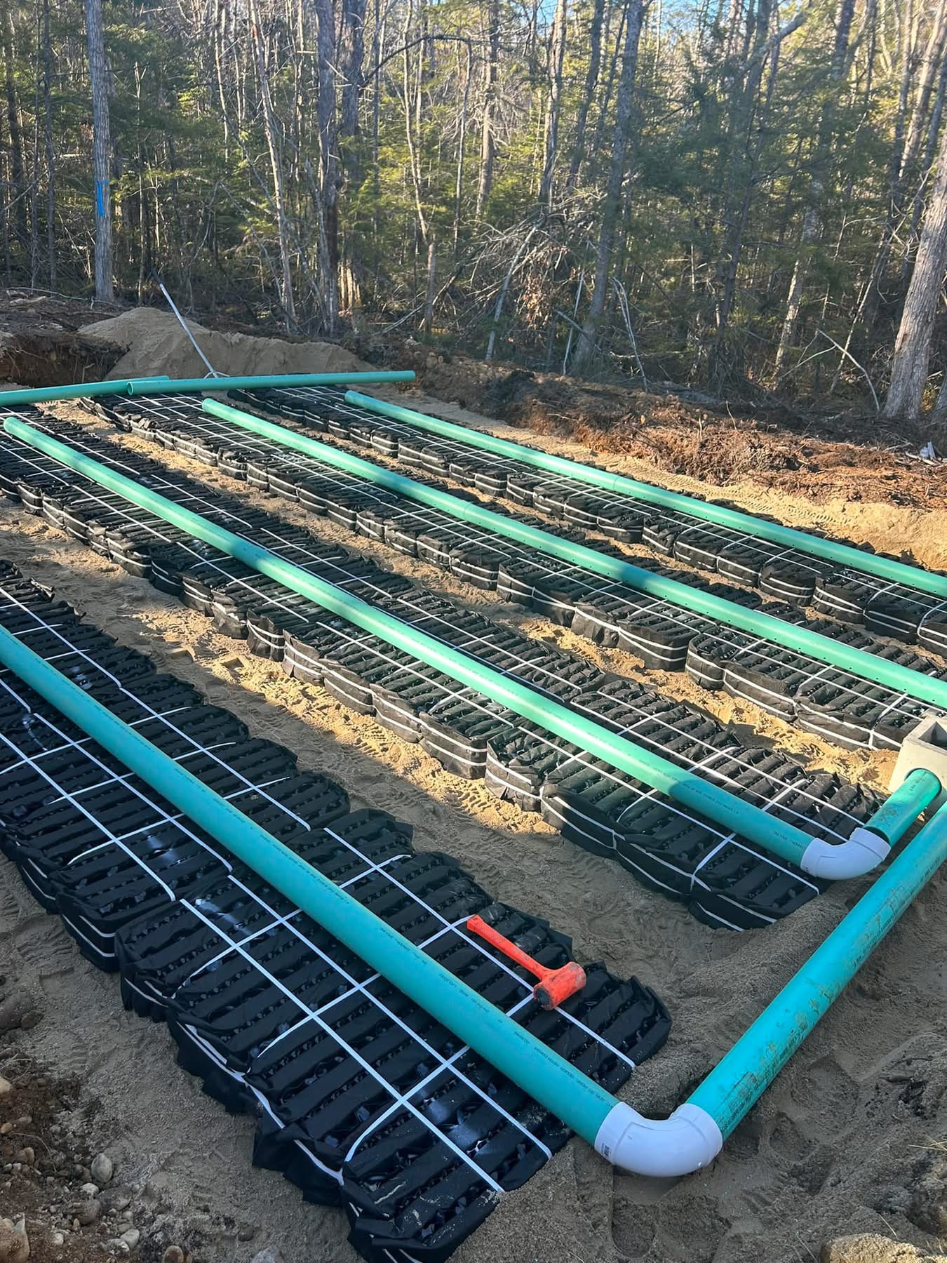 Septic leach field chambers and distribution piping installed in sand bed
