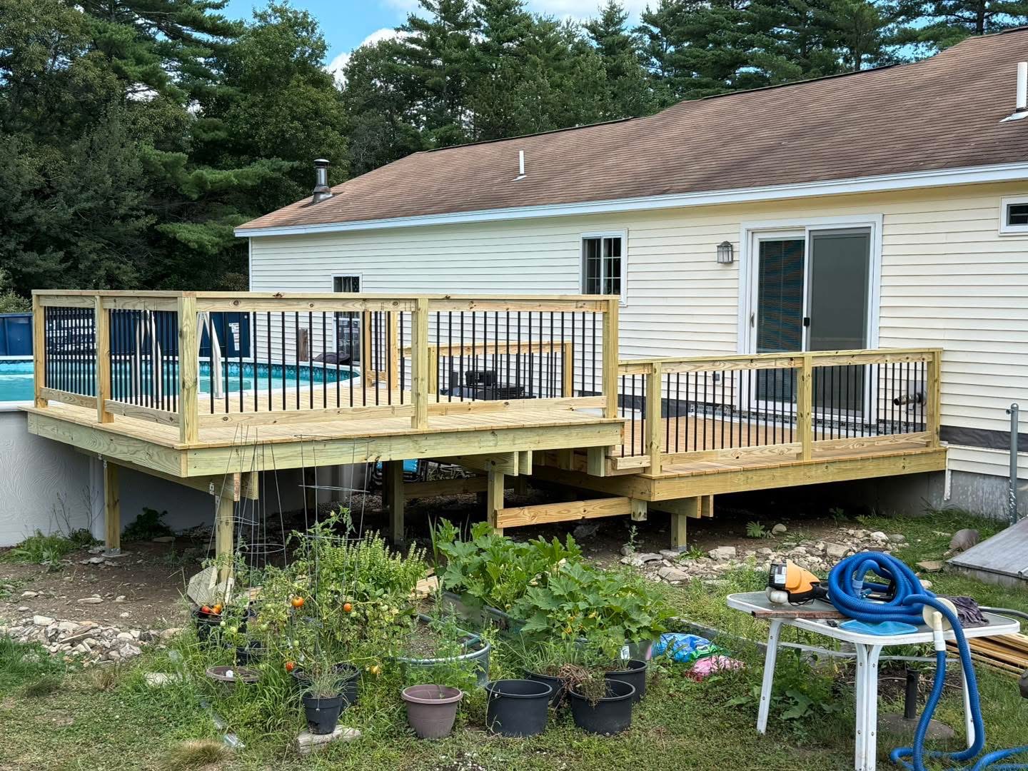 Pressure-treated pool deck with black aluminum balusters