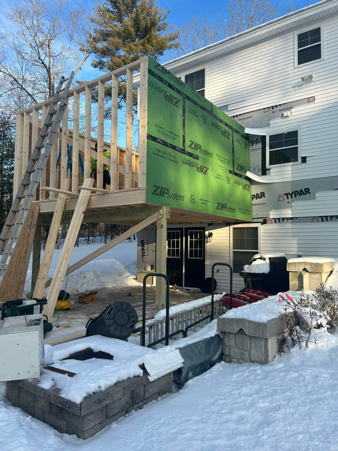 Second-story home addition framed and sheathed during winter construction