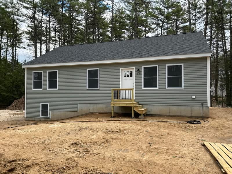 Completed gray ranch home with white trim and new entry steps